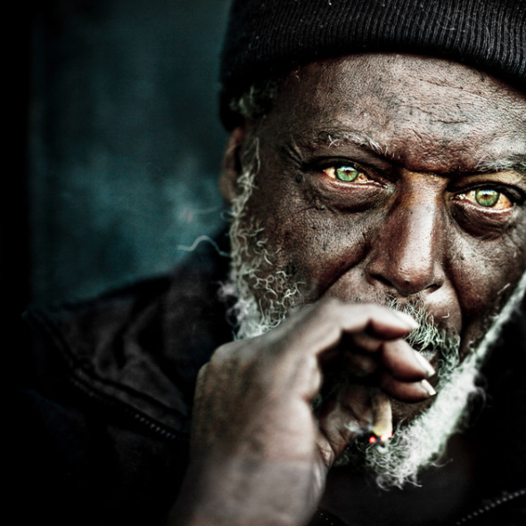 BLACK MAN WITH GREEN EYES SMOKING