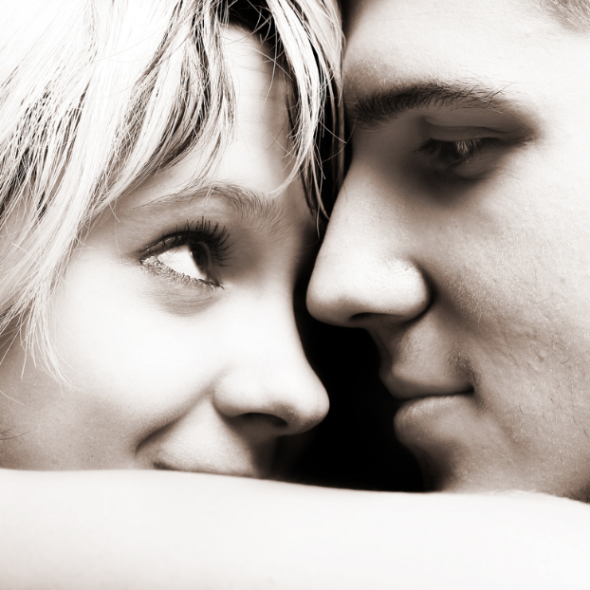 GIRL IN BED SMILING AT GUY